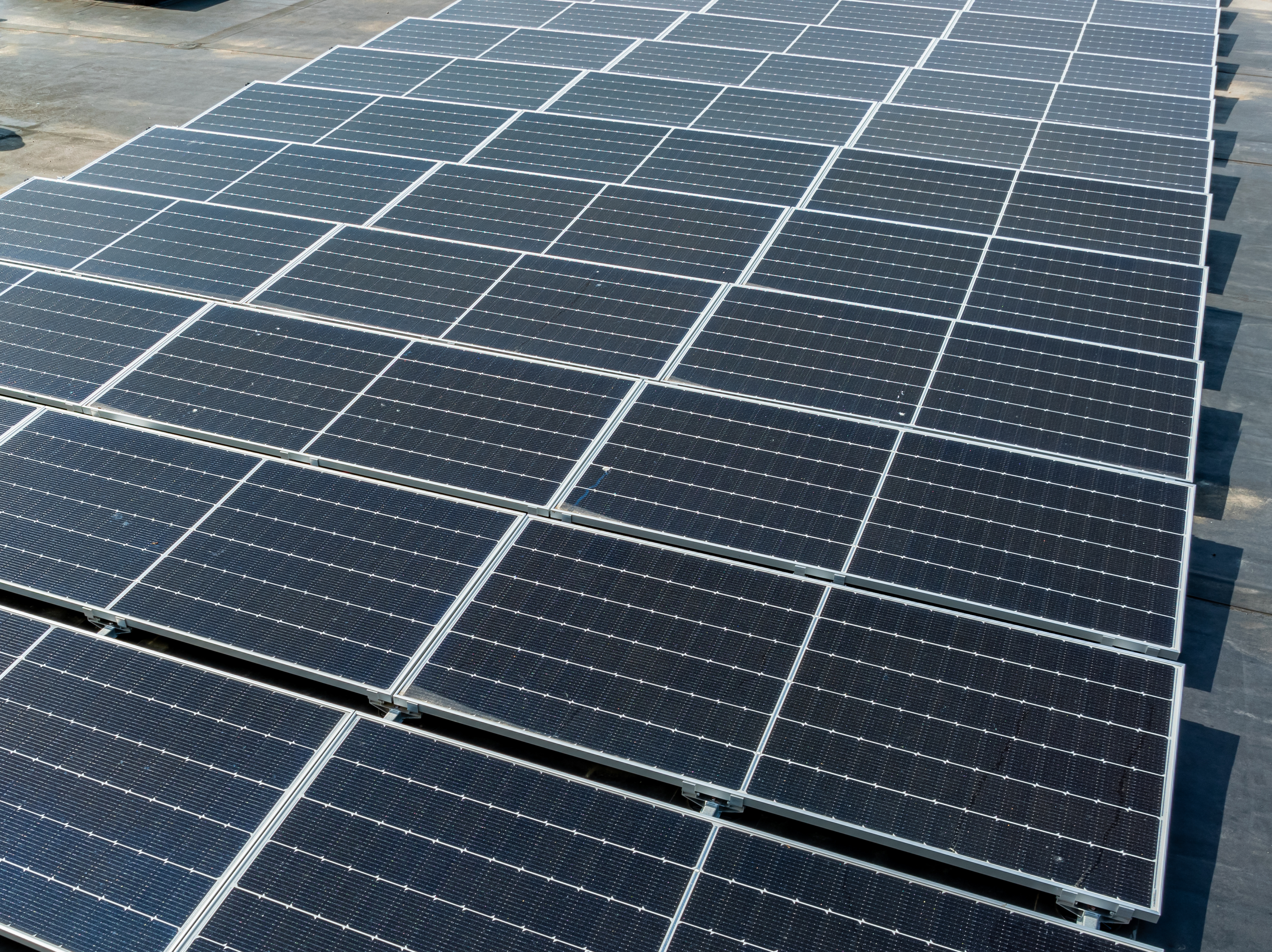 Solar photovoltaic panels installed on a commercial rooftop